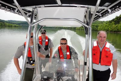A U.S. Army Corps of Engineers commander piloting a boat on Cordell Hull Lake.