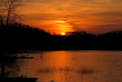 Sunset over Dale Hollow Lake with picnic tables silhouetted at left.